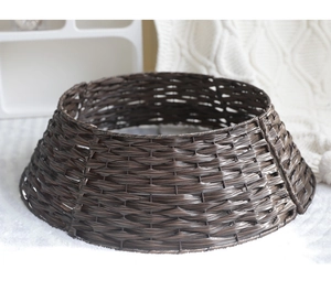Detail of dark brown hand-woven Christmas tree skirt basket on a white cozy blanket