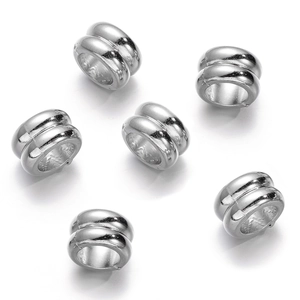 Macro detail of silver CCB spacer beads with double ring drum design for DIY jewelry