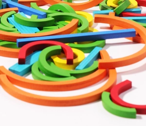 Close-up of assorted colorful geometric wooden blocks showing smooth natural texture