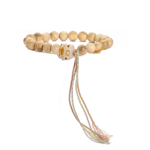 Detailed close-up of a wooden bead bracelet with a cat charm and colorful tassel