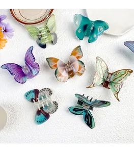 Detailed view of translucent butterfly hair claws in seven colors with elegant textures