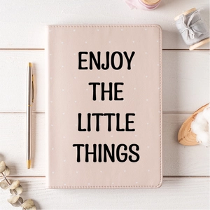 Detail showing pink leather journal with black Enjoy The Little Things artistic text