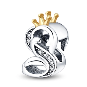Detailed view of silver swan bead charm with gold crown and sparkling cubic zirconia stones