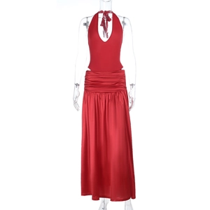 Detail of red halter neck dress with pleated waist and glossy satin long skirt