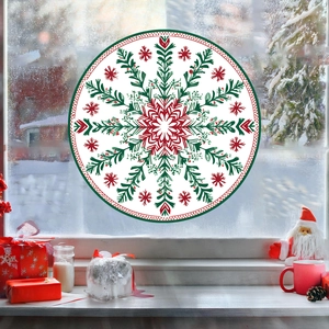 Detail of red and green snowflake window stickers on glass with festive Christmas decor