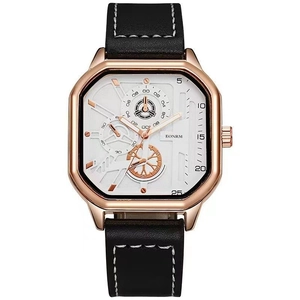 Detail view of the rose gold chronograph watch case with black leather strap and white dial