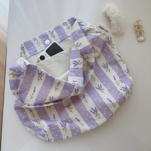 Detail view of cotton bag interior with magnetic clasp and inner pocket for phone storage