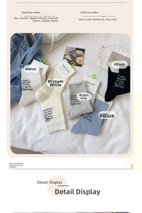 Detail view of cotton crew socks in multiple colors with medium elasticity and soft texture