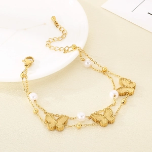 Detail showing double-layered chain with gold butterfly charms and white pearls
