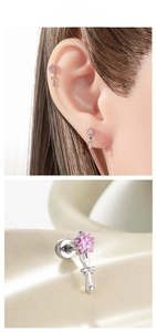 Detailed view of silver bow and pink star zircon stud earring on professional model