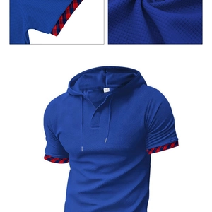 Detail of blue waffle knit hoodie polo with red and blue checkered ribbon on the sleeve cuff