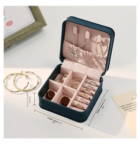Mini navy leather jewelry box with pink velvet lining and gold ring storage slots