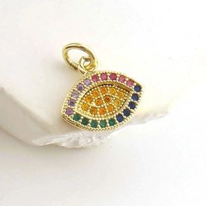 Macro detail of a golden evil eye pendant with vibrant multi-color zircon stones