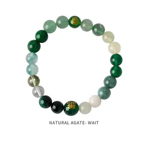Close-up of natural agate beaded bracelet with deep green beads and gold engraving