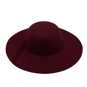 Detail of burgundy wide-brim wool felt hat featuring a matching decorative band