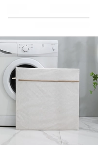 Detail of white fine mesh laundry bag with khaki zipper and protective cover