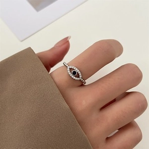 Close-up of evil eye ring with white cubic zirconia and black gemstone in silver