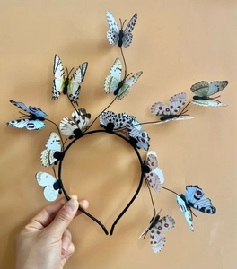 Detail of realistic butterfly headband with colorful blue and yellow winged ornaments