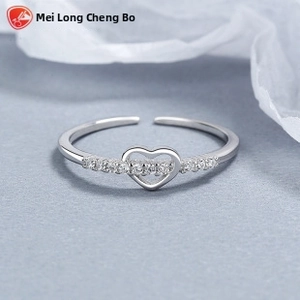 Macro detail of 925 silver heart open ring featuring sparkling micro-set cubic zirconia