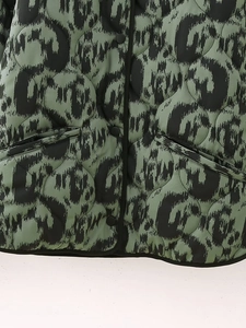 Detail of army green quilted jacket with vintage abstract print and black snap buttons