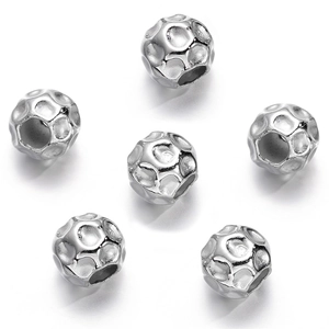 Close-up of silver CCB beads with hammered texture and large holes for jewelry making