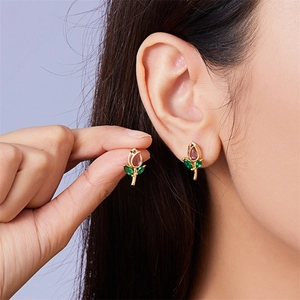 Close-up of elegant tulip earrings featuring pink and green gems on a female model