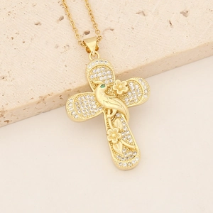 Close-up of 18K gold-plated cross necklace with cubic zirconia and bird engraving