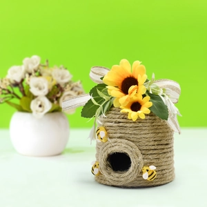 Detail of handmade jute rope honeycomb ornament with sunflowers and faux bees