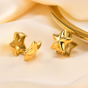 Detailed close-up of 18k gold star-shaped hoop earrings on elegant silk background