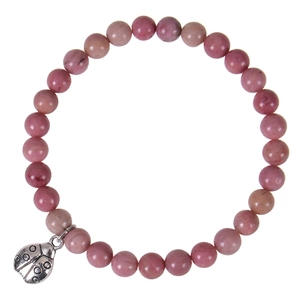 Detail of pink natural stone beads and silver ladybug charm on elastic bracelet
