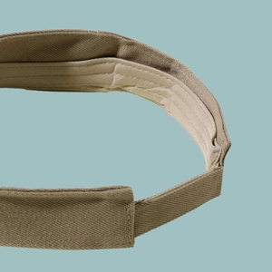 Close-up of khaki cotton sun hat velcro strap with reinforced double stitching detail