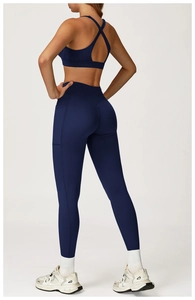 Back view of deep blue yoga set showing criss-cross sports bra and high waist leggings