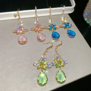Macro shot of colorful zircon flower and water drop earrings in gold plating