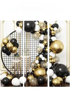 Detail of premium black, gold, and white balloon arch with shimmering confetti accents