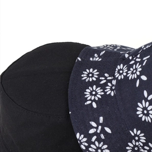 Close-up of black twill cotton fabric and navy floral daisy print on bucket hat