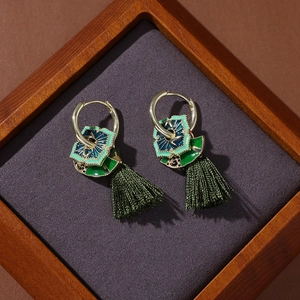 Detailed close-up of Neo-Chinese fan-shaped pearl tassel earrings with green enamel charm