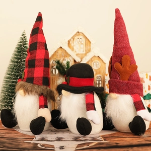 Three Nordic Christmas gnomes with plaid hats and long white beards on wooden background