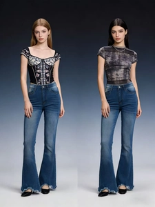 Detail of high waisted flare jeans with distressed raw hems and vintage blue wash finish