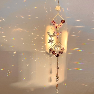 Golden suncatcher with natural amethyst stones and crystal ball creating rainbow reflections