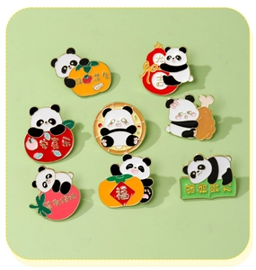 Flat lay of eight cute cartoon panda enamel pins with colorful Chinese blessing motifs