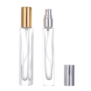 Portable 10ml glass perfume spray bottles with elegant gold and silver caps on white background