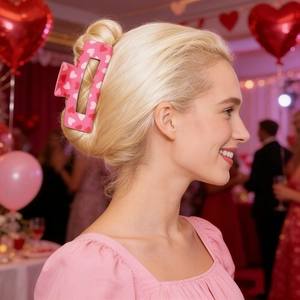 Pink square hair claw clip with red heart patterns used for an elegant hair updo