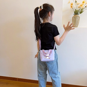 Rear view of a girl wearing the light purple cartoon rabbit crossbody snack bag