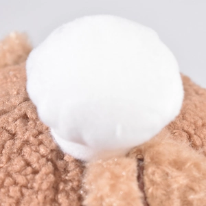Detail of soft lamb wool fabric and plush pom-pom on the children baseball cap