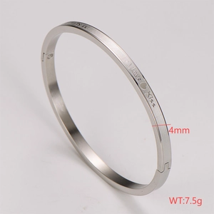 Detail of 4mm stainless steel silver cuff bracelet with Love Kiss engraved text