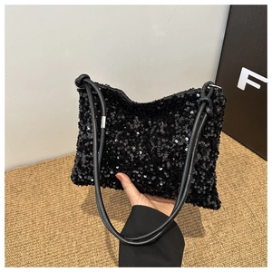 Detail of elegant black sequin shoulder bag showing shimmering texture and slim strap