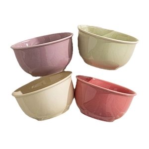 Minimalist ceramic bowls set in pastel colors with glossy glaze finish on white background
