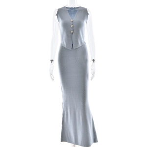 Detailed texture of grey knitted fabric on a slim fit V-neck vest and long skirt set