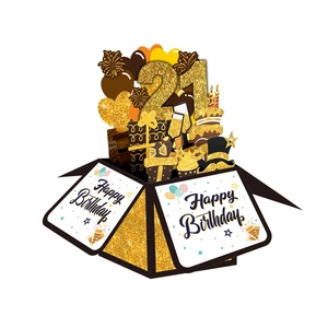 Macro detail of 3D 21st birthday pop-up card box with gold glitter and black accents