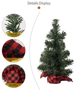 Detail display of mini artificial Christmas tree showing needle texture and red plaid base